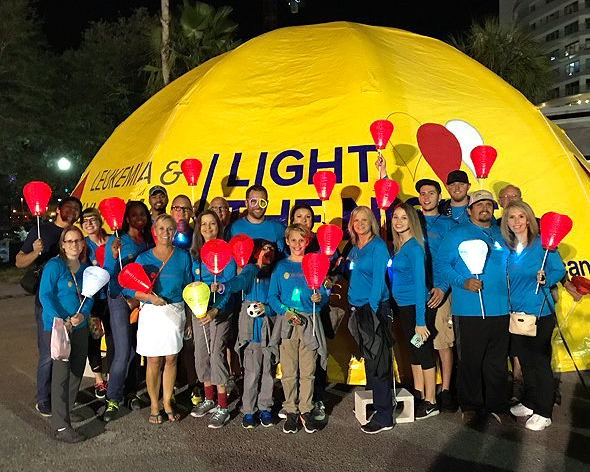 Members of Walbridge’s Florida Group gather for the Leukemia & Lymphoma Society’s Light The Night Walk on Nov. 18 in Tampa. Money raised by the event funds treatments that save lives. The Walbridge squad, captained by Frank Rygiel (wearing the purple and green glasses), raised $10,300, making them the third-ranking corporate fundraising team.